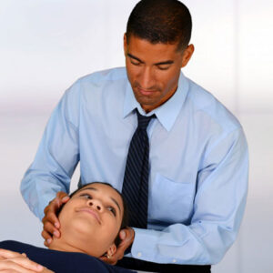 chiropractor adjusting a woman’s neck
